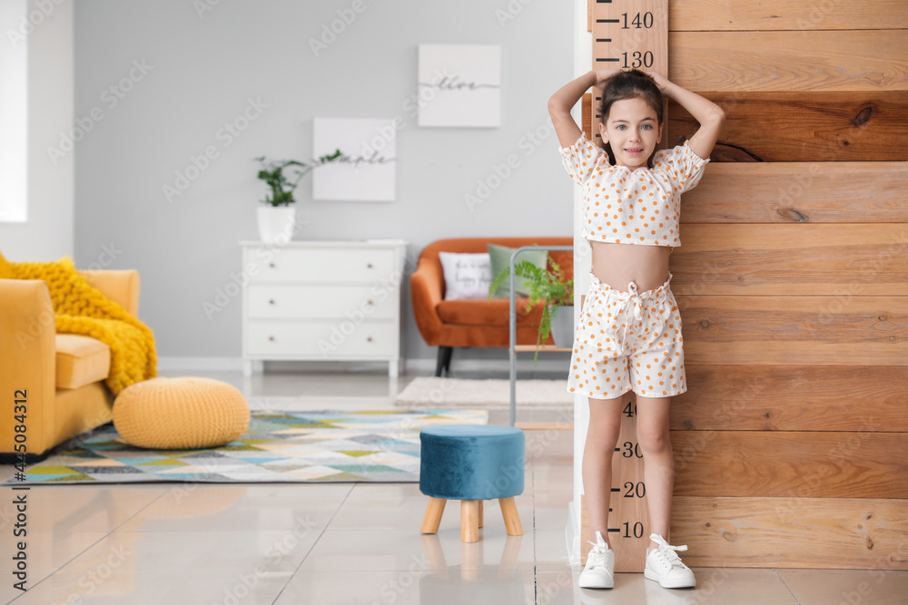 Little girl measuring height at home