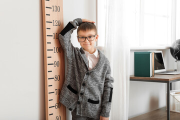 Sticker - Little boy measuring height at home