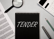 Word tender on office desk with stationery stuff. Business concept
