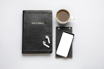 Sticker - Holy Bible, cup of coffee, mobile phone and earphones on white background