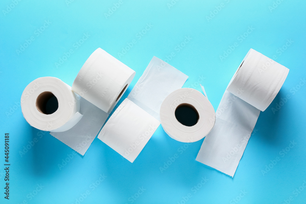 Rolls of toilet paper on color background