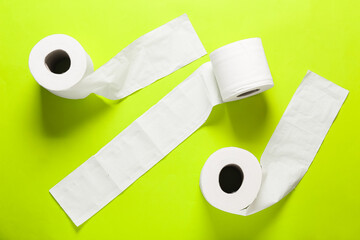 Rolls of toilet paper on color background