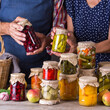 Senior couple holding in hands preserved food