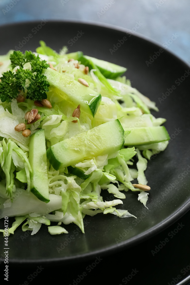 Plate with tasty cabbage salad on color background, closeup