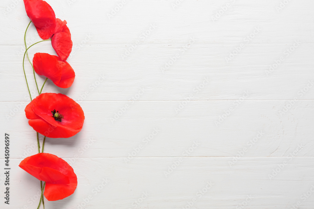 Beautiful red poppy flowers on light wooden background