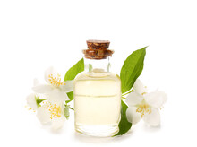 Bottle Of Essential Oil And Jasmine Flowers On White Background