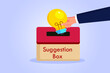 Suggestion vector concept. Hand putting a light bulb into a suggestion box