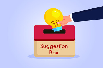 Suggestion vector concept. Hand putting a light bulb into a suggestion box