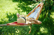 Summer vacation - lovely girl in a colorful hammock. High quality photo