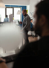 Poster - Architect profession man looking at layout construction maquette building model plan for design architecture development. Urban designer adult working at desk office on project