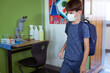 © WavebreakMediaMicro - Caucasian schoolboy in classroom wearing face mask and schoolbag