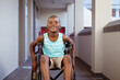© WavebreakMediaMicro - Portrait of smiling disabled african american schoolboy sitting in wheelchair in school corridor