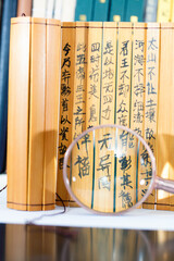 Wall Mural - Bamboo slips and magnifying glass with Chinese characters