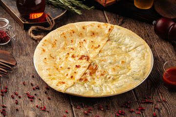 Wall Mural - Caucasian flat bread khychin with cheese and greens filling