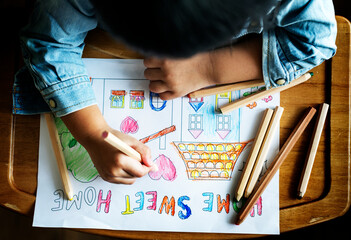 Young boy coloring home sweet home