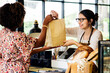 © Rawpixel.com - Black customer buying bakery products