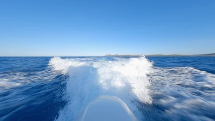 Wall Mural - Stunning view of a water trail formed by a recreational boat sailing at high speed on a blue water. Sardinia, Italy.