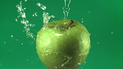 Poster - Super slow motion water droplets fall on a rotating fresh apple. On a green screen.Filmed on a high-speed camera at 1000 fps