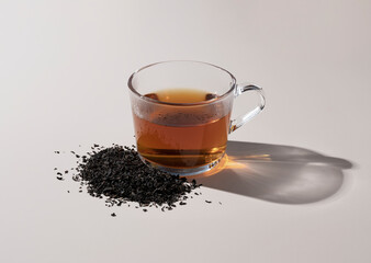 Tea and tea leaves on beige background