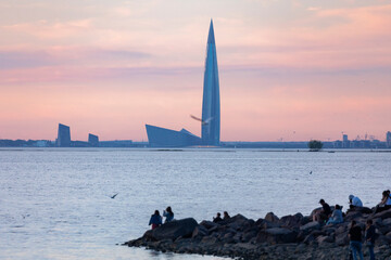 Russia. Saint-Petersburg. Citizens admire the sunset on the background of the Lakhta Center skyscraper.