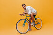 © Look! - Handsome bearded man with brown hair in cool t-shirt and beige modern shorts posing with bicycle and looking into camera..