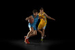 © master1305 - Two basketball players in action and motion isolated on dark black studio background. Advertising concept. Strong Caucasian athletes practicing with basketball ball.