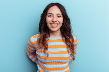 Young mexican woman isolated on blue background happy, smiling and cheerful.