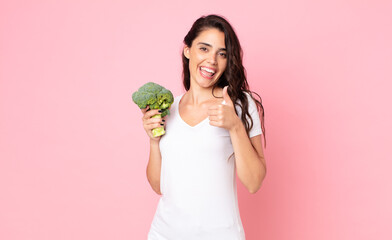 Wall Mural - pretty young woman holding a broccoli