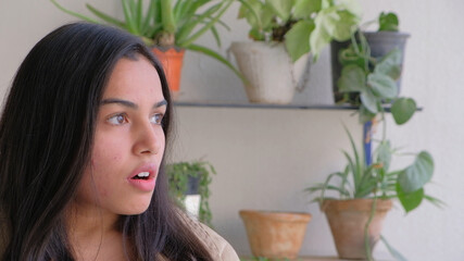 Canvas Print - Shallow focus of a beautiful Indian woman looking at something with a shocked facial expression