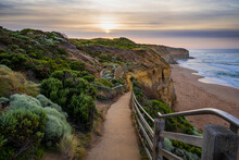 Looking Down Coastal Walking Track Towards The Sunrise And The Beach Below