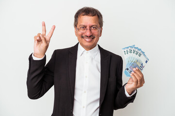 Middle aged indian business man holding bills isolated on white background showing number two with fingers.