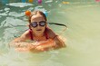 A girl playing in garden swimming pool. Portret outside in water. 