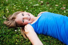 Pretty Blue-eyed Tween Girl Lying In The Grass