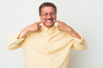 Wall Mural - Middle aged indian man isolated on white background smiles, pointing fingers at mouth.