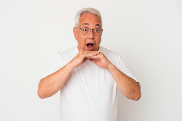 Wall Mural - Senior american man isolated on white background praying for luck, amazed and opening mouth looking to front.