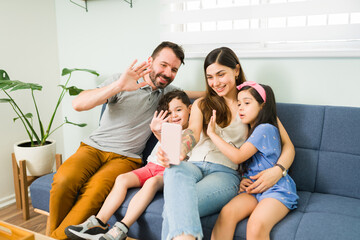 Wall Mural - Latin mom, dad and kids during a video call