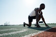 © DmitryStock - Photo below. African American athlete runner stands at the start of the race. Active sport concept