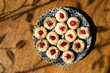 Traditional Moroccan handmade cookies in a ceramic plate on a wooden table.