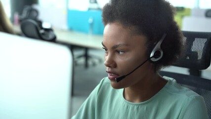 Wall Mural - Mixed race African American woman with headset using computer, talking, working customer support service operator