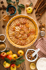 Canvas Print - Thanksgiving autumn apple pie with fresh fruits and walnuts on wooden table, top view