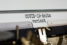 Covid-19 Delta Virus Variant Symbol. Words 'Covid-19 Delta Variant' Typed On Retro Typewriter. Medical And COVID-19 New Delta Plus Variant Concept.