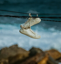 Closeup Shot Of White Shoes Hanging On Power Lines