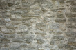 © Kati Lenart - A light grey, medieval stone wall. Textured background with copyspace.