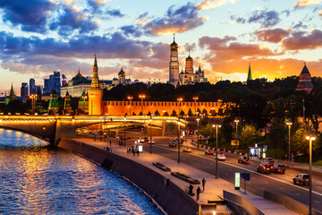 Wall Mural - View of the Moscow Kremlin and Moscow City Skyscrapers along the quay of the Moscow river during evening sunset blue hour