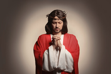 Poster - Jesus Christ with crown of thorns praying on beige background