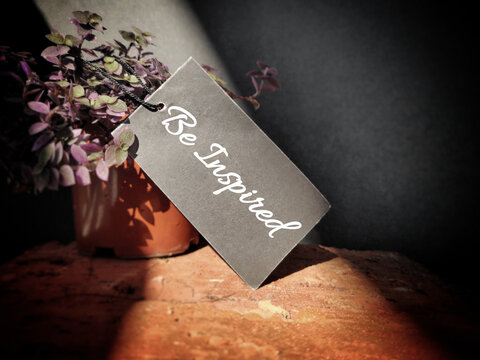 Inspirational and Motivational Concept - 'Be Inspired' written text with vintage background. Stock photo.
