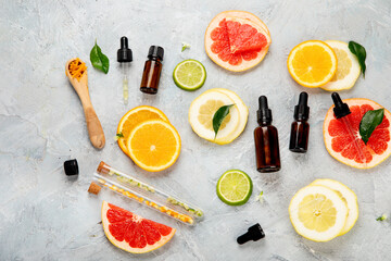 Sticker - Bottle of essential aroma oils with citrus on light gray background.