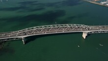 Iconic Auckland Harbour Bridge. Aerial Reveal Of Beautiful Cityscape On New Zealand Seaside