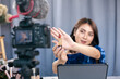 © ME Image - Selective focus hand, Asian woman beauty blogger review show lipstick cosmetic to share on social media. Beautician tutorial live online.