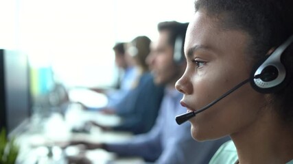 Canvas Print - Mixed race African American woman with headset using computer, talking, working customer support service operator